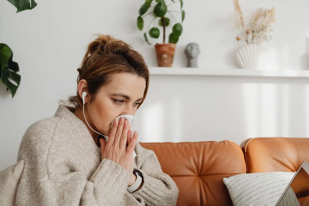 Woman blowing her nose